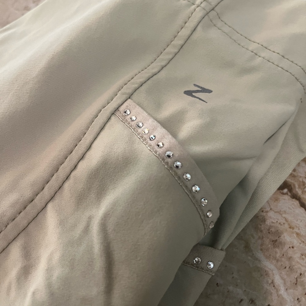 Tan Women's full seat breeches with Rhinestone Detail on pockets.